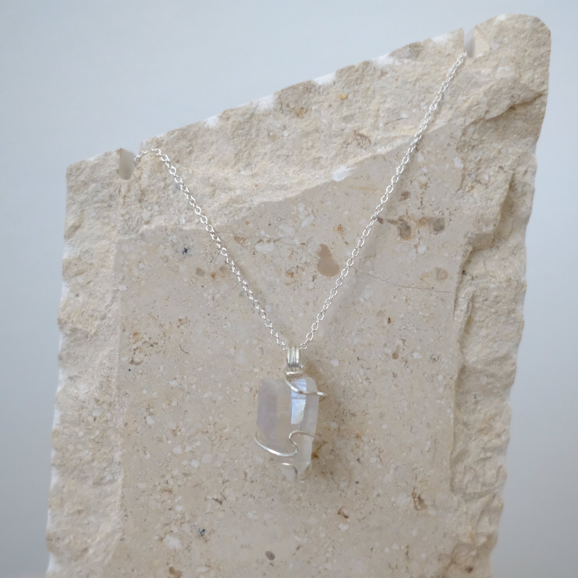 “Close-up of Handmade Sterling Silver Angel Aura Quartz Necklace showing iridescent rainbow crystal wrapped in hypoallergenic .925 sterling silver, artisan-crafted by J’s Divine Jewelry Designs.”