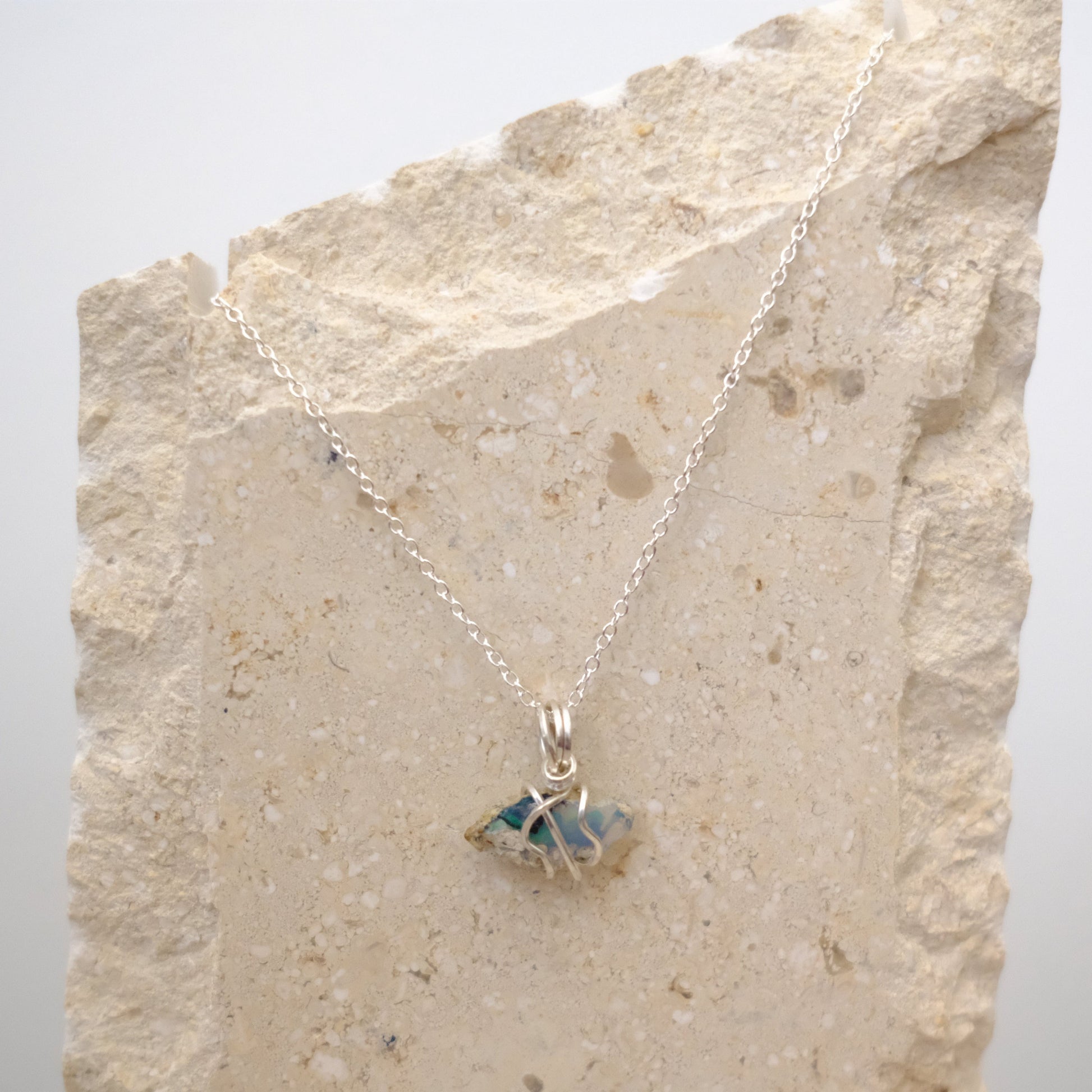 Close-up of natural Ethiopian Opal pendant glowing with play-of-color