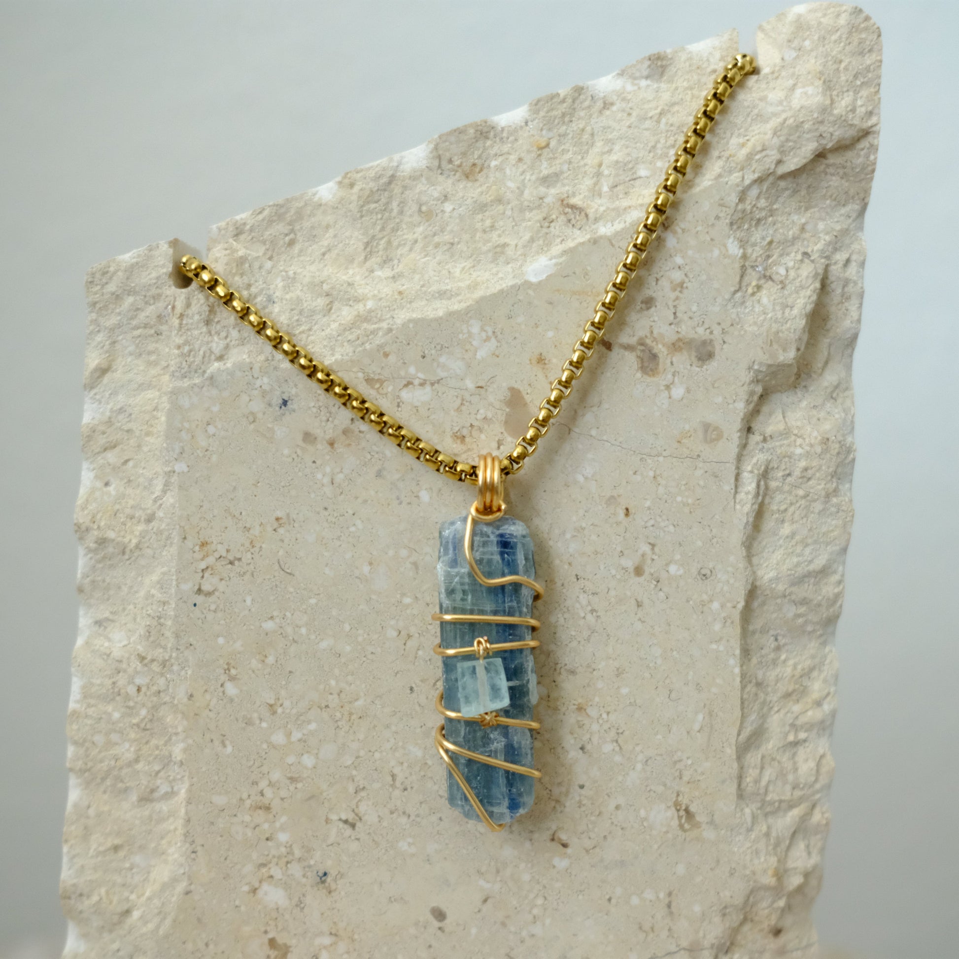 Closeup of handmade gold-plated Kyanite and Aquamarine crystal necklace, luxury artisan jewelry by J’s Divine Jewelry Designs