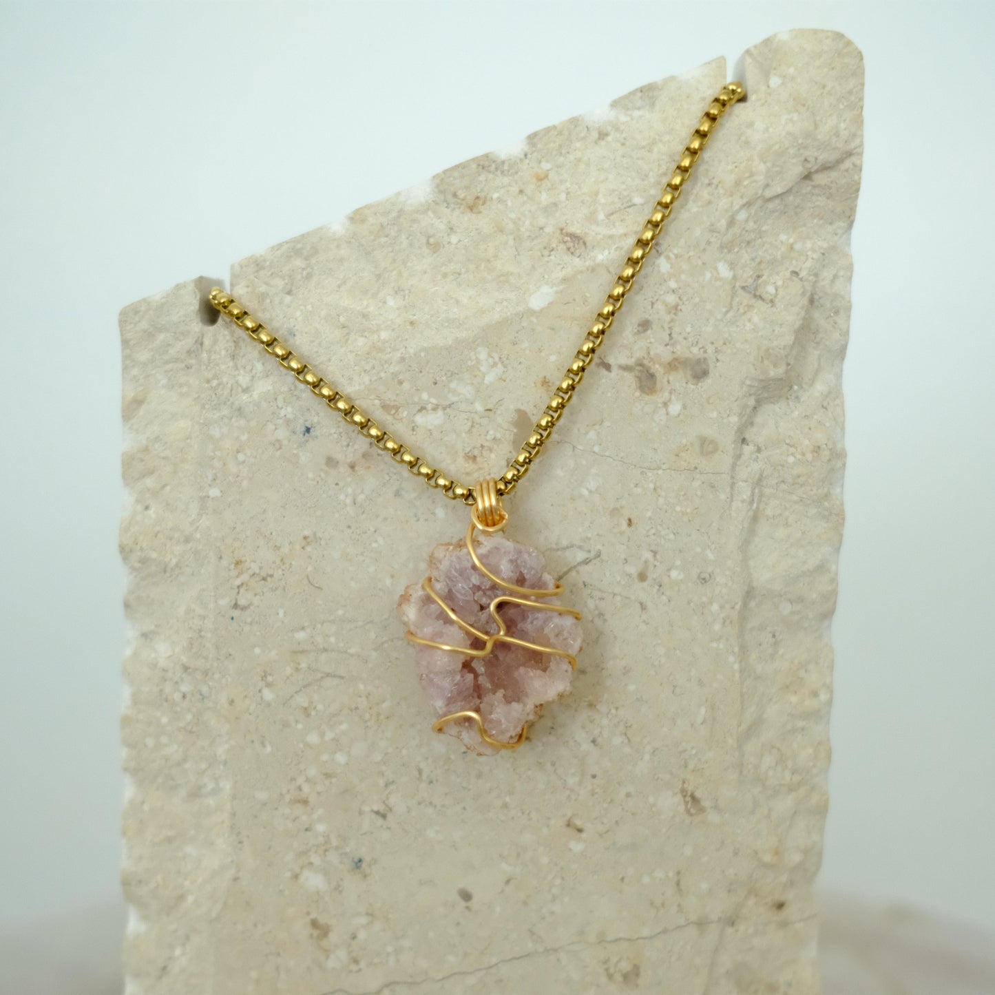 Handmade gold necklace with a pink amethyst crystal