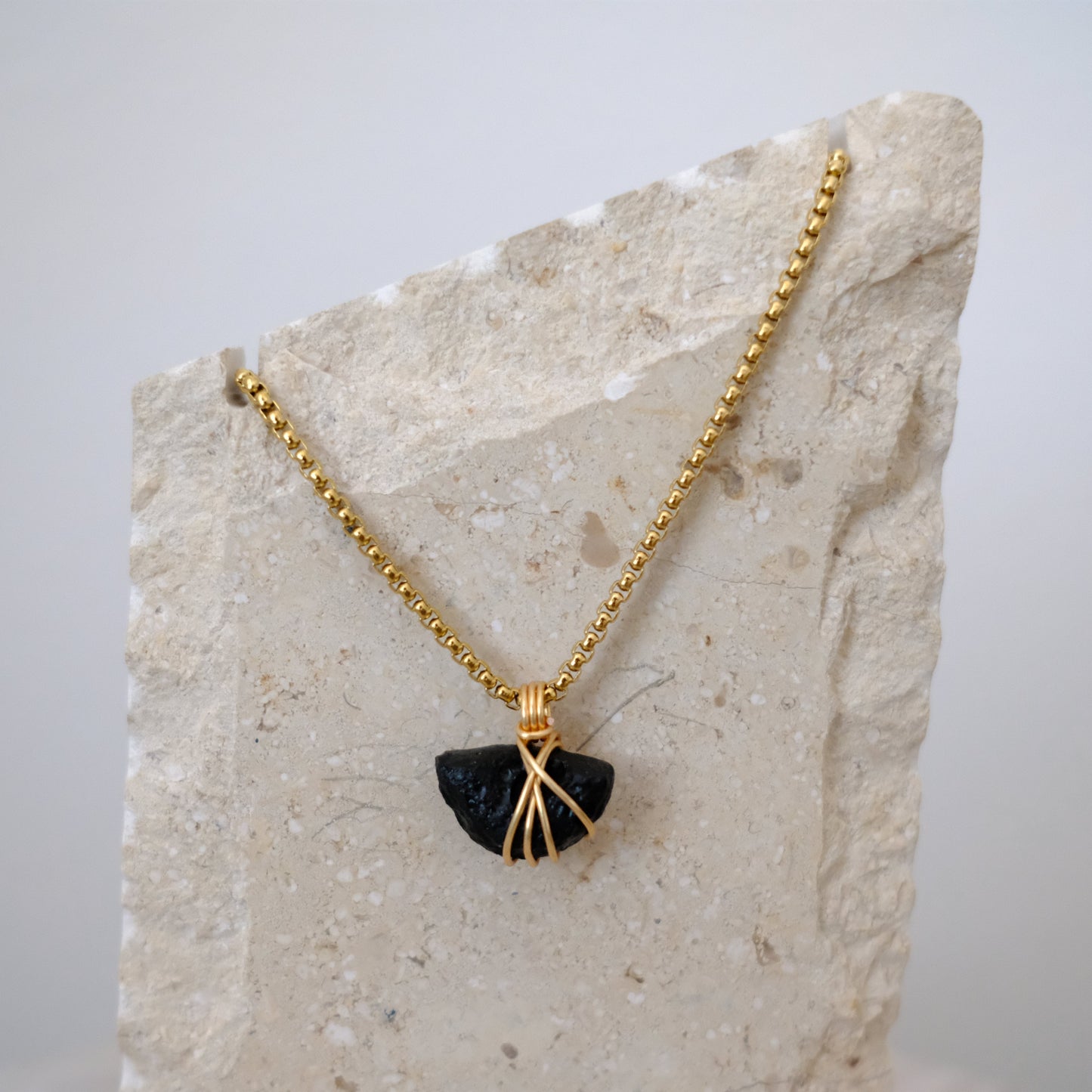 Handmade gold-plated tektite necklace with genuine dark stone, luxury spiritual jewelry for transformation and protection.