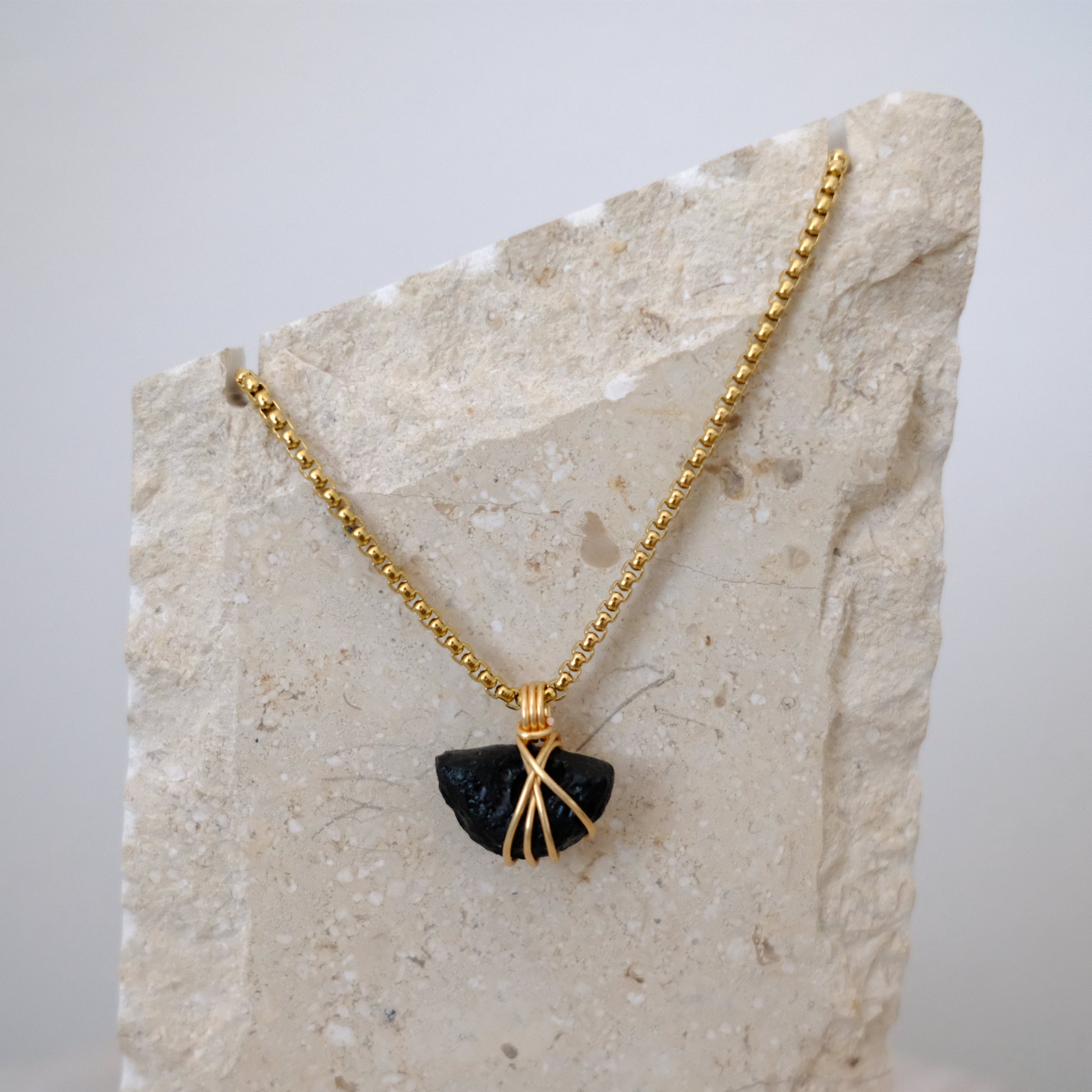 Handmade gold-plated tektite necklace with genuine dark stone, luxury spiritual jewelry for transformation and protection.