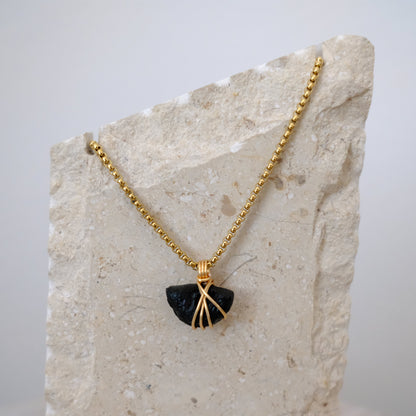 Handmade gold-plated tektite necklace with genuine dark stone, luxury spiritual jewelry for transformation and protection.