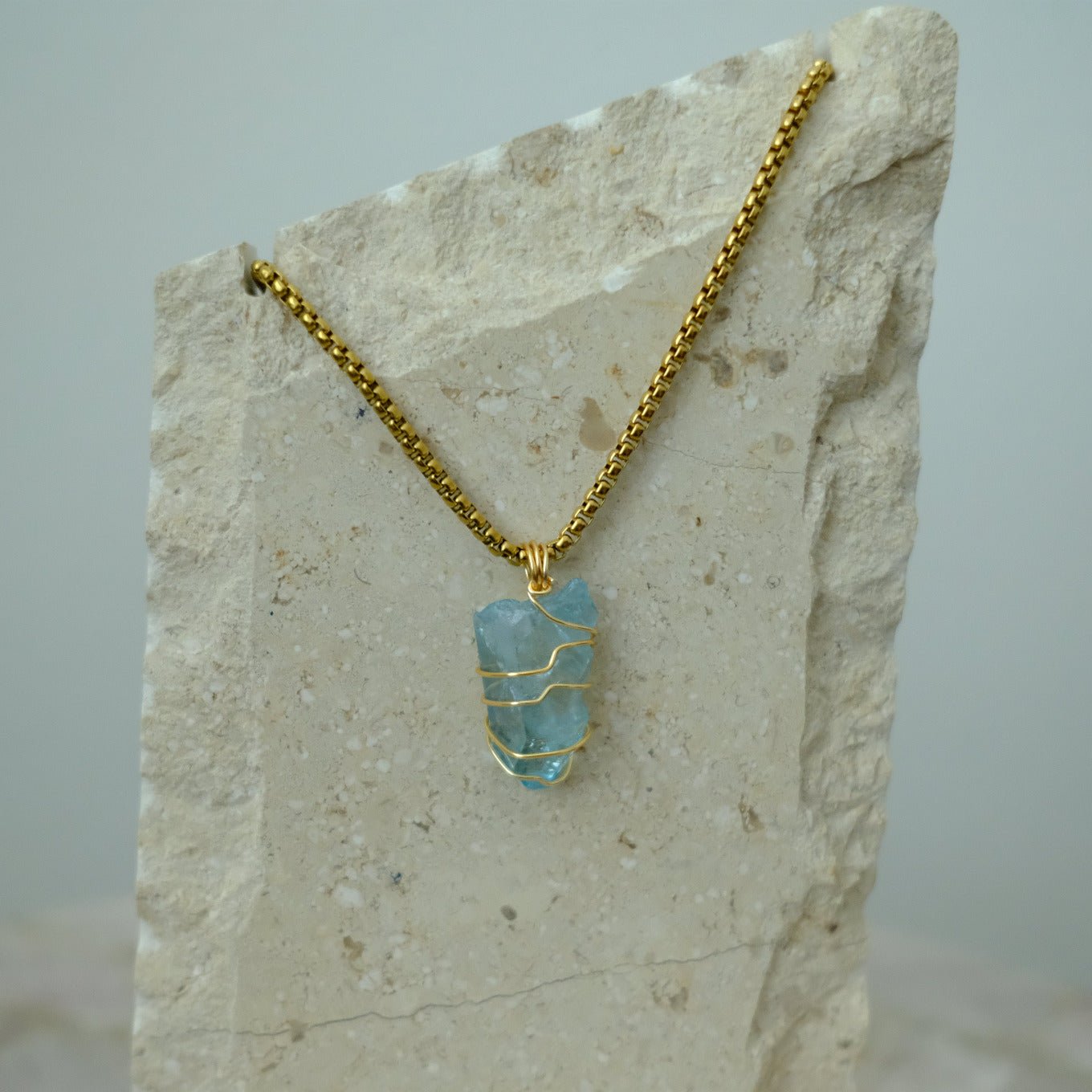 Handmade gold-plated aqua aura quartz necklace with iridescent blue crystal, luxury spiritual jewelry for calm, clarity, and protection.