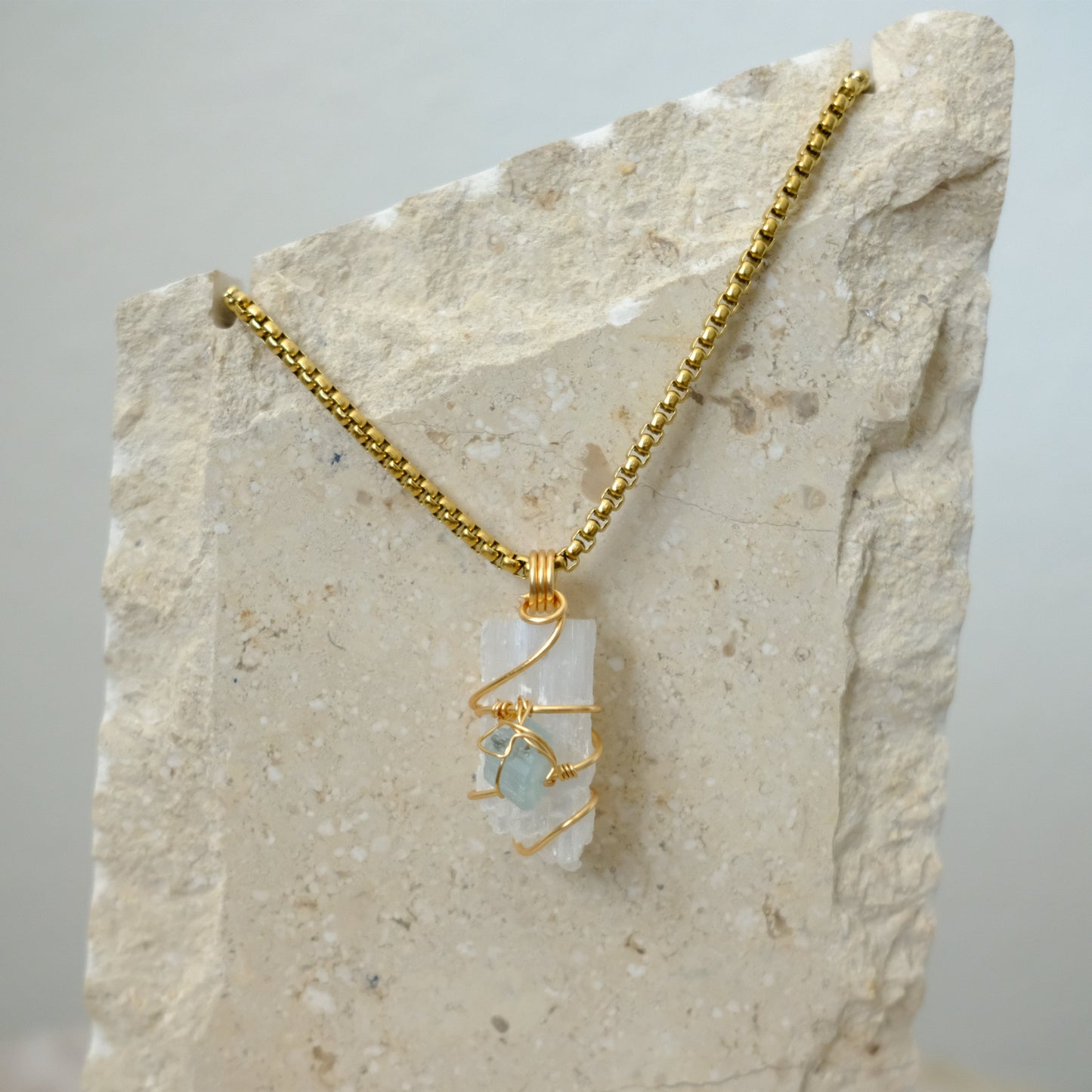 Closeup of handmade gold-plated Selenite and Aquamarine crystal necklace, luxury artisan jewelry by J’s Divine Jewelry Designs