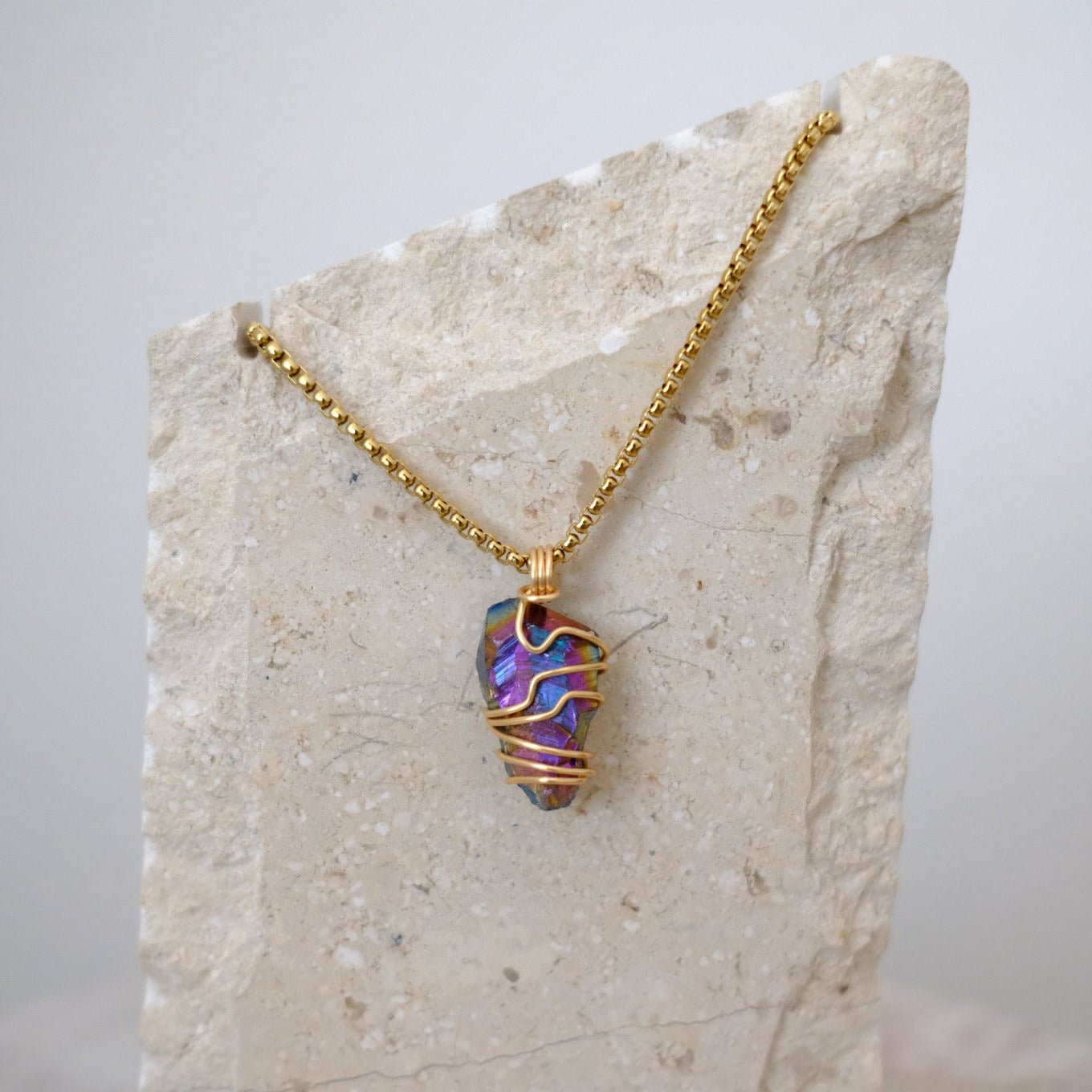Handmade gold-plated titanium aura quartz necklace with rainbow crystal, luxury spiritual jewelry for strength and high energy.
