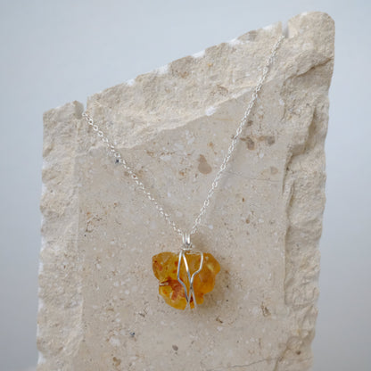 “Close-up of Handmade Sterling Silver Amber Necklace showcasing warm golden Amber crystal wrapped in hypoallergenic .925 sterling silver, artisan-crafted by J’s Divine Jewelry Designs.”